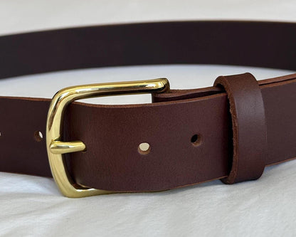 Brown leather belt with a gold buckle on a white background