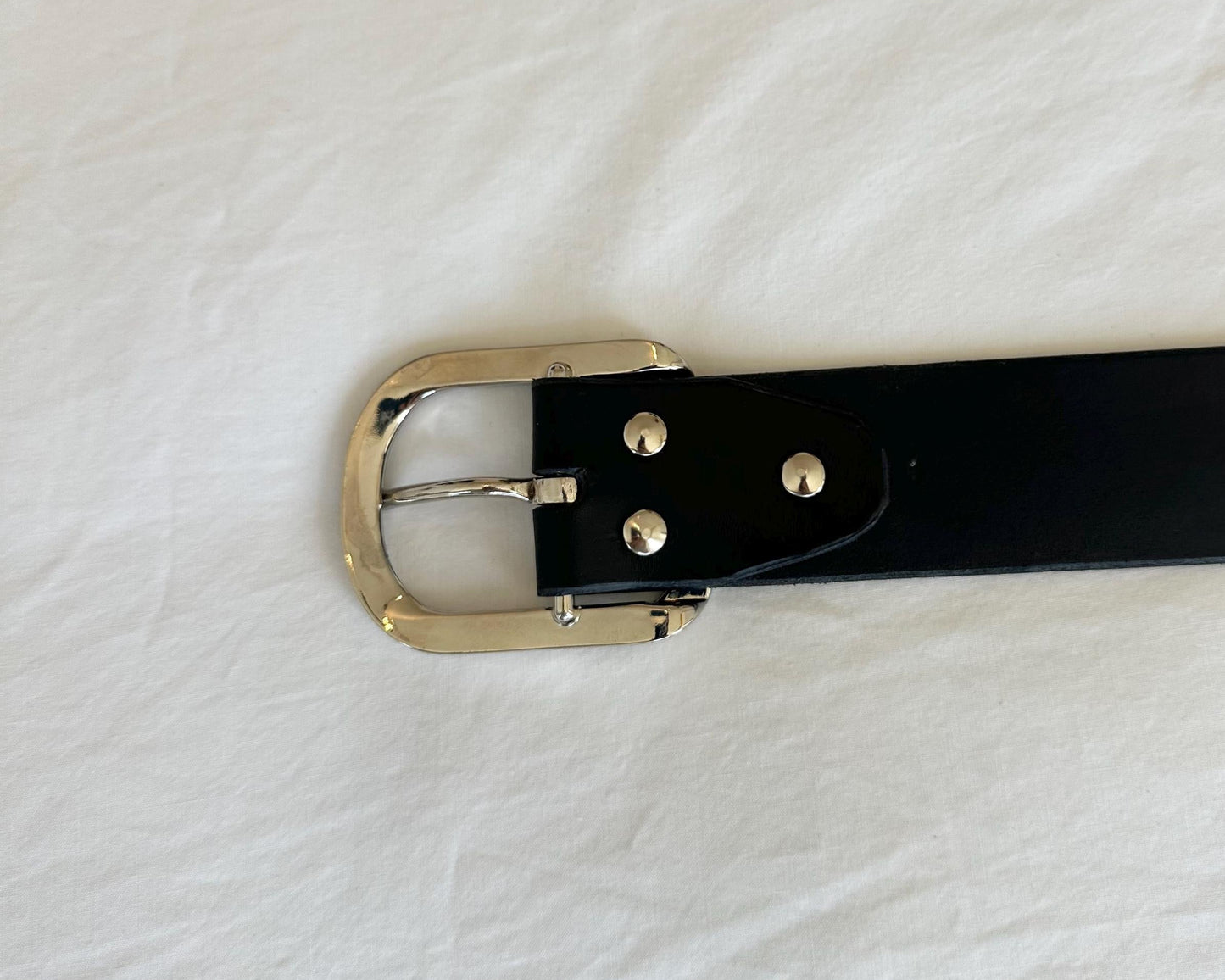 Black belt with a silver buckle on a white background