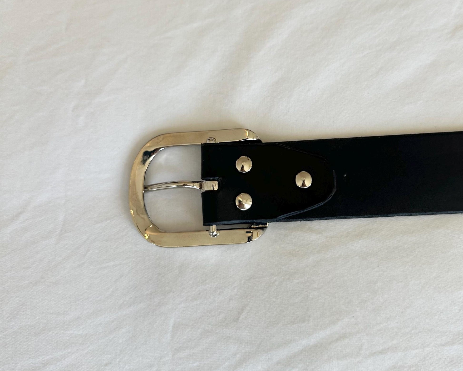 Black belt with a silver buckle on a white background